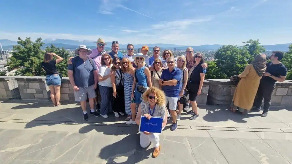 Secret Italia tour group with their tour director overlooking city and mountain views