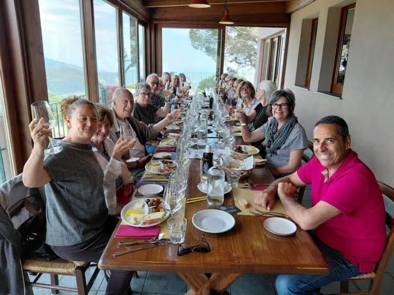 Secret Italia guests toasting with Italian wine at a panoramic terrace lunch